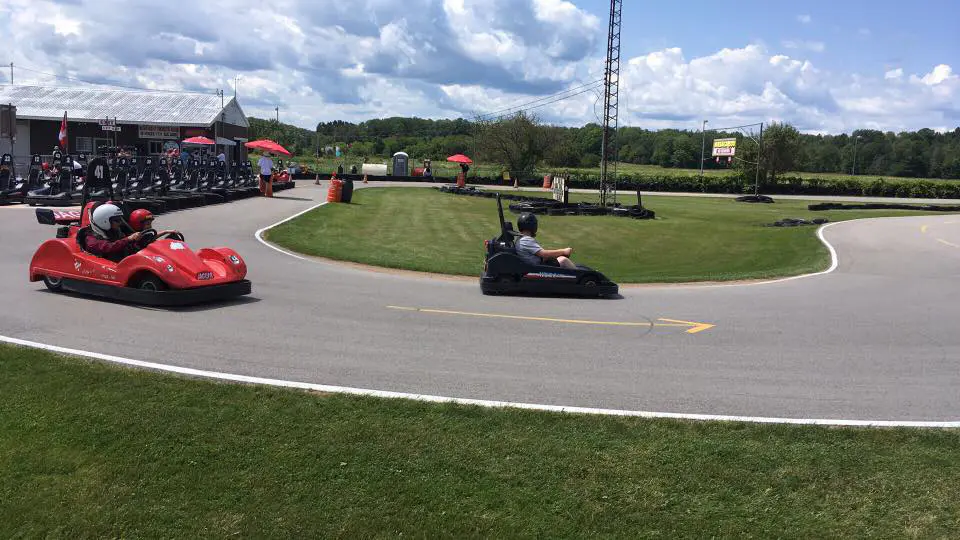 3 People riding go karts on a track